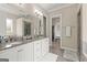 Bathroom featuring double sinks, granite countertops, a glass enclosed shower, and a walk in closet at 195 Berry Hill Ln, Tyrone, GA 30290