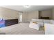 Spacious carpeted bedroom featuring a sectional sofa, dresser, and natural lighting at 195 Berry Hill Ln, Tyrone, GA 30290