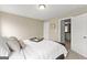Neutral bedroom with bed featuring white linens and woven bed frame and decorative pillows at 195 Berry Hill Ln, Tyrone, GA 30290
