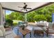 Cozy covered patio with ceiling fan, comfortable seating and view of the private, wooded backyard at 195 Berry Hill Ln, Tyrone, GA 30290