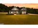 Charming single-Gathering home features a manicured lawn and welcoming front porch with stone and siding accents at 195 Berry Hill Ln, Tyrone, GA 30290