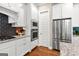 Modern kitchen boasts stainless steel appliances, granite countertops, and dark backsplash at 195 Berry Hill Ln, Tyrone, GA 30290