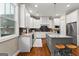 Spacious kitchen featuring an island, white cabinets, granite countertops, and hardwood floors at 195 Berry Hill Ln, Tyrone, GA 30290