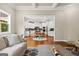 Open-concept living room with access to a modern kitchen featuring white cabinets at 195 Berry Hill Ln, Tyrone, GA 30290