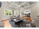 Bright living room featuring a coffered ceiling and a view to the kitchen with white cabinets at 195 Berry Hill Ln, Tyrone, GA 30290