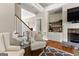 Cozy living room featuring a stone fireplace, wood floors, and built-in shelving at 195 Berry Hill Ln, Tyrone, GA 30290