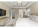 Spacious main bedroom offers carpeting, a tray ceiling, a ceiling fan, and access to the en suite bathroom at 195 Berry Hill Ln, Tyrone, GA 30290