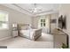 Bright main bedroom features a tray ceiling, neutral tones, plush carpeting, and a large window for ample natural light at 195 Berry Hill Ln, Tyrone, GA 30290