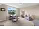Home office features a large window, neutral carpet, desk, and a gray armchair at 195 Berry Hill Ln, Tyrone, GA 30290