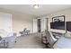 Bright office includes a desk, gray chair, and sitting area, all with neutral carpet at 195 Berry Hill Ln, Tyrone, GA 30290