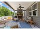 Covered outdoor patio area with fireplace, ceiling fan, and lounge seating at 195 Berry Hill Ln, Tyrone, GA 30290
