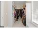 Organized walk-in closet with ample storage and shelving, complete with a window for natural light at 195 Berry Hill Ln, Tyrone, GA 30290