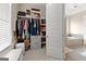 Walk-in closet with custom shelving and storage solutions, as well as a glimpse of the en suite bathroom at 195 Berry Hill Ln, Tyrone, GA 30290