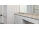 Bathroom featuring granite vanity, modern fixtures, and laminate flooring at 1512 Big Bud Ln, Locust Grove, GA 30248
