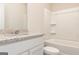 Bathroom with a light colored vanity and white tub at 1512 Big Bud Ln, Locust Grove, GA 30248