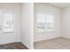 Well-lit bedroom featuring neutral paint, large window, vinyl floors and an adjacent door leading to the backyard at 1512 Big Bud Ln, Locust Grove, GA 30248