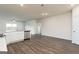 Open-concept living space featuring vinyl flooring, stainless steel appliances, and an adjacent door for backyard access at 1512 Big Bud Ln, Locust Grove, GA 30248