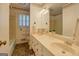 Bathroom featuring double sink vanity, a large mirror, and wallpaper at 2400 White Pine Ln, Mansfield, GA 30055