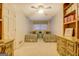 Twin beds, light carpet, built-in bookcase, and cream colored paneled walls at 2400 White Pine Ln, Mansfield, GA 30055