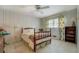 A bedroom featuring floral curtains, a full size bed with a carved wooden frame, and wood paneled walls at 2400 White Pine Ln, Mansfield, GA 30055