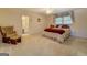 Carpeted bedroom with natural light from the window and en-suite bathroom at 2400 White Pine Ln, Mansfield, GA 30055