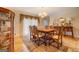 Formal dining room with hardwood floors, ornate furnishings, and elegant chandelier lighting at 2400 White Pine Ln, Mansfield, GA 30055