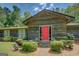 Charming home entrance with a vibrant red door, surrounded by manicured landscaping at 2400 White Pine Ln, Mansfield, GA 30055