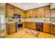 A well-lit kitchen featuring wood cabinetry, stainless steel appliances, and tile backsplash at 2400 White Pine Ln, Mansfield, GA 30055