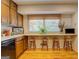 Kitchen with window breakfast bar and seating for four on hardwood floors at 2400 White Pine Ln, Mansfield, GA 30055