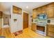 Classic eat-in kitchen featuring wood cabinets, stainless steel appliances, and hardwood floors at 2400 White Pine Ln, Mansfield, GA 30055