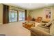 Expansive living room with neutral carpet, opens to a screened porch and a view to the hallway at 2400 White Pine Ln, Mansfield, GA 30055