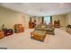 Spacious living room with comfortable seating and neutral carpet flooring, ideal for entertaining at 2400 White Pine Ln, Mansfield, GA 30055