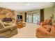 Inviting living room with stone fireplace and sliding glass doors to the outdoor living space at 2400 White Pine Ln, Mansfield, GA 30055