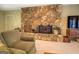 Cozy living room with a stone fireplace and wood burning stove, perfect for cold days at 2400 White Pine Ln, Mansfield, GA 30055