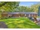 Expansive backyard featuring a covered patio, outdoor seating area, and lush green lawn, perfect for entertaining at 603 Lakewood Dr, Social Circle, GA 30025
