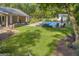 Green backyard with a gorgeous pool area with an outdoor seating space and an outdoor shed at 603 Lakewood Dr, Social Circle, GA 30025