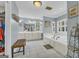 Bright bathroom with a soaking tub, double vanity, shuttered windows, and ample cabinet space at 603 Lakewood Dr, Social Circle, GA 30025