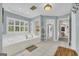 Bright bathroom featuring a soaking tub, lots of natural light, with a walk-in shower through an open doorway at 603 Lakewood Dr, Social Circle, GA 30025