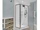 Walk-in shower with glass doors, a shower head, and a built-in seat with a small storage unit to the side at 603 Lakewood Dr, Social Circle, GA 30025