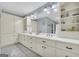 A spacious bathroom featuring double sinks with white countertops, a large mirror, and plenty of storage at 603 Lakewood Dr, Social Circle, GA 30025