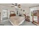 Charming bedroom with a ceiling fan, dresser, and beautiful natural light from the two windows at 603 Lakewood Dr, Social Circle, GA 30025