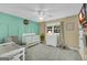 Cozy Bedroom featuring a white crib, changing table, and modern decor at 603 Lakewood Dr, Social Circle, GA 30025