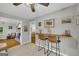 Stylish breakfast bar area featuring a wooden counter, two stools, and views of the fireplace at 603 Lakewood Dr, Social Circle, GA 30025