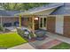Charming covered patio with seating, dining, and entertaining space, perfect for outdoor living at 603 Lakewood Dr, Social Circle, GA 30025