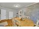 Comfortable dining room featuring a large table, brick wall accents, and access to the kitchen at 603 Lakewood Dr, Social Circle, GA 30025
