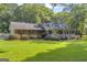 Beautiful single-Gathering home boasting a lush green lawn and a welcoming covered front porch, perfect for relaxing at 603 Lakewood Dr, Social Circle, GA 30025