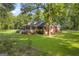Charming one-story home featuring a cozy front porch, well-maintained lawn, and mature trees for added privacy at 603 Lakewood Dr, Social Circle, GA 30025
