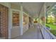 Inviting covered porch with ample seating and decorative touches, offering a relaxing outdoor space at 603 Lakewood Dr, Social Circle, GA 30025