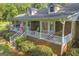 Inviting covered porch with rocking chairs and patriotic decor offering a cozy spot to enjoy the outdoors at 603 Lakewood Dr, Social Circle, GA 30025