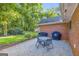 Relaxing gravel patio area with outdoor dining set, grill, and serene backyard view at 603 Lakewood Dr, Social Circle, GA 30025